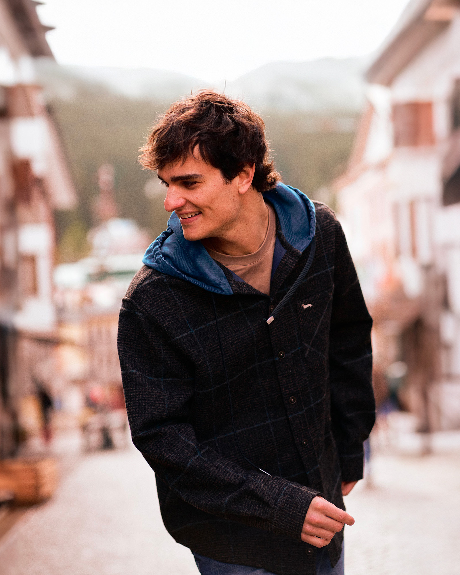 Person standing in front of a large stylized flower on a light background
